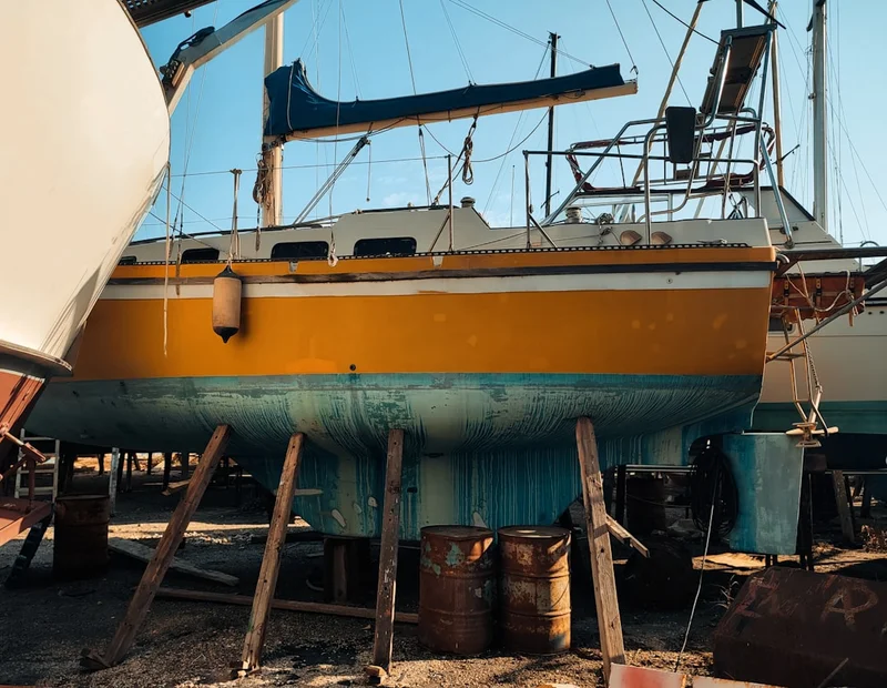 Boat on supports at a boatyard service facility